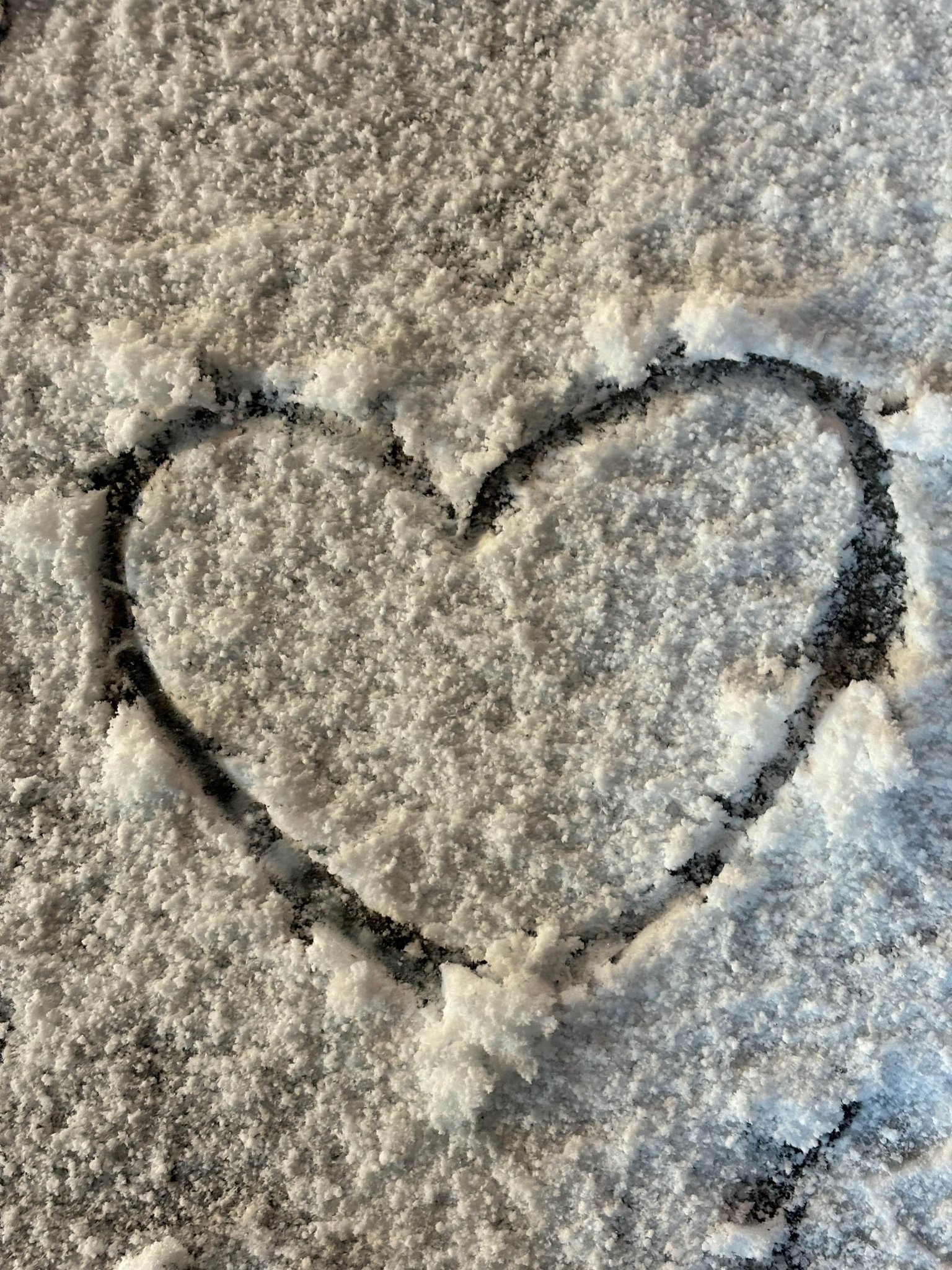 a heart drawn by jimin in the snow on the ground..